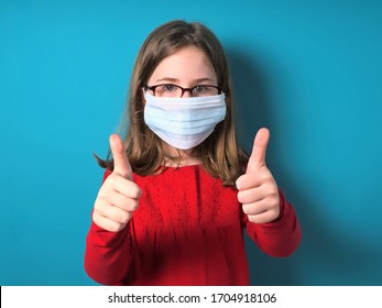 Girl Wearing A Surgical Protective Mask And Thumbs Up