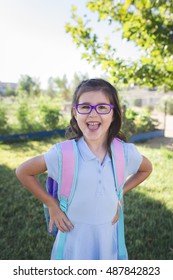 A Girl Wearing A Uniform And A Backpack Is Ready For Her First Day Of School.