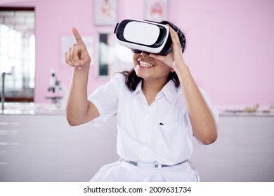 Girl Wearing VR  Virtual Reality Goggles Interaction Headset , Experiencing  New Way Of Learning By Digital Simulation , Future Education Concept 