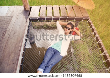 Similar – Woman with sunglasses raising her arms over nature background