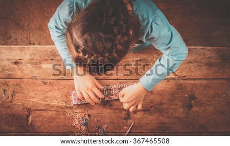 Similar – Baby Mädchen spielt mit Haarspangen, die auf dem Boden sitzen.