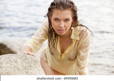 Girl In Wet Shirt On Seashore