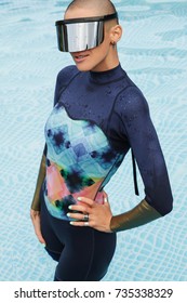 Girl In A Wet Suit Posing In The Pool