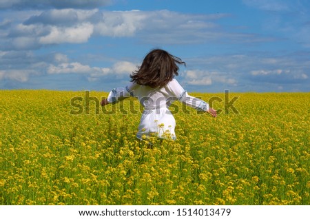 Similar – Image, Stock Photo girl walking in a field with yellow flowers sunny day