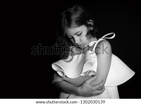 Similar – thin hands of an adult woman hugging a young girl