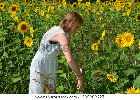 Similar – eine frau vor  einer blumenwiese. blumen pflücken