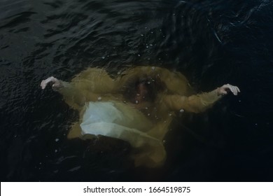 Girl in a white dress under water. A woman drowns in a lake. Folklore.