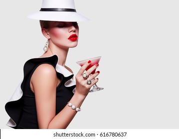 Girl In White Hat Covers Her Face. Girl With A Glass Of Cocktail In Hand.
Girl Drinks Cocktail. Strawberry Milkshake. The Charming Stranger.