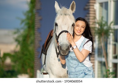 A girl with a white horse - Powered by Shutterstock