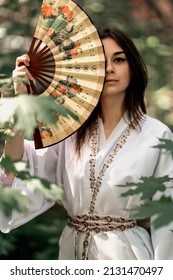 Girl In A White Kimono With A Fan In Her Hands