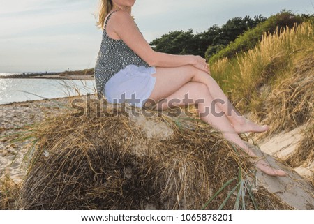 Young woman and Labrador at the Baltic Sea beach