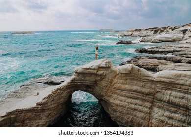 girl in a white swimsuit on the rocky seashores in Cyprus - Powered by Shutterstock