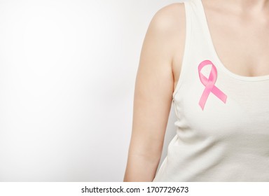 Girl in a white T-shirt with a pink ribbon on her chest. - Shutterstock ID 1707729673