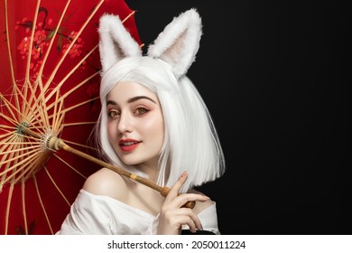 Girl in white wig and carnival costume, cosplay cat woman.