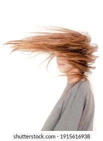 Girl Whose Hair Is Blowing In The Wind Over Her Face