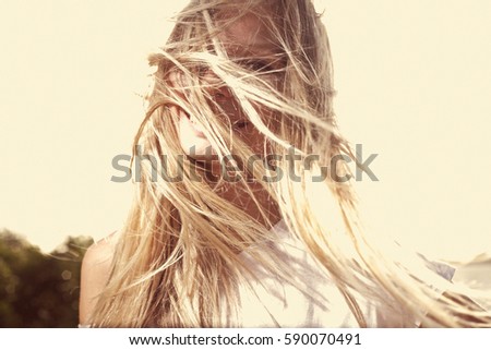 Similar – Image, Stock Photo Young woman at the stand blond hair blows around her