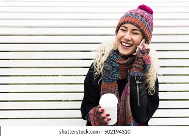 Girl In Winter Clothes Talking On The Phone And Laughing