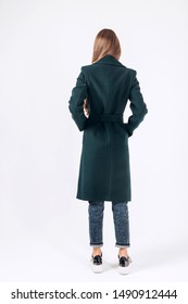 Girl In A Winter Coat On A White Background. Young Fashionable Woman In Stylish Outerwear. Girl In A Coat Rear View.