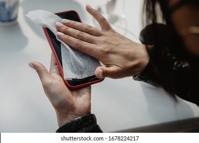 Girl Wipes Phone With Anti-bacterial Wipe