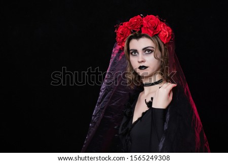 girl witch vampire in a wreath of red roses and a black dress