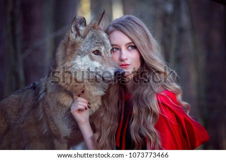 girl with a wolf in a red cloak