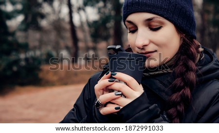 Girl in the woods with a cup. Close-up