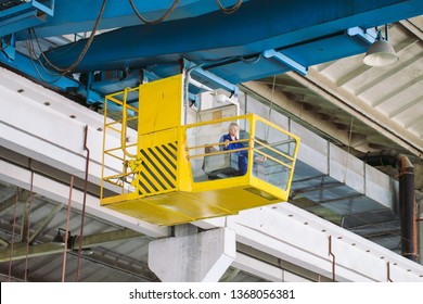 The girl working in the cab of a crane. Heavy industry, metal factory. - Shutterstock ID 1368056381
