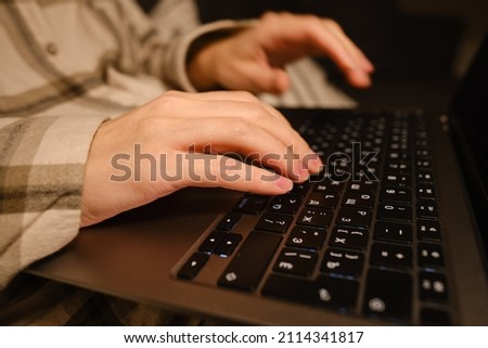Girl works with a laptop and a smartphone in bed at home or in hotels. Distant work. Office at home. Woman in the bedroom is typing on a laptop, distance learning for students, surfing the Internet