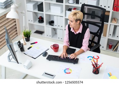 The girl works in the office at the computer. - Powered by Shutterstock