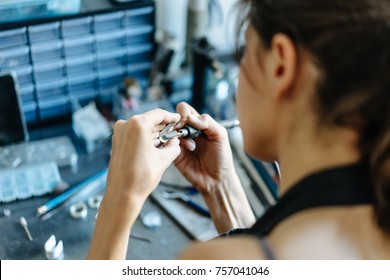 The Girl Works On A Jewelry In The Workshop