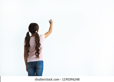 The girl writing on the white wall