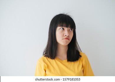 Girl In Yellow T-shirt Make An Eye Roll Due To Something Annoying Her.