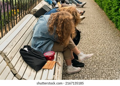 Girlfriend comforts her friend hugging her on a white wooden bench in a city park. Problems of youth, consolation and help in difficult times - Powered by Shutterstock