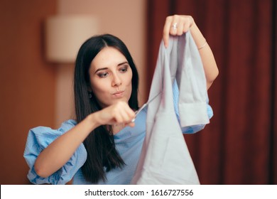 Girlfriend Having Jealousy Crisis Cutting Male Shirts. Angry wife seeking revenge for infidelity and lies