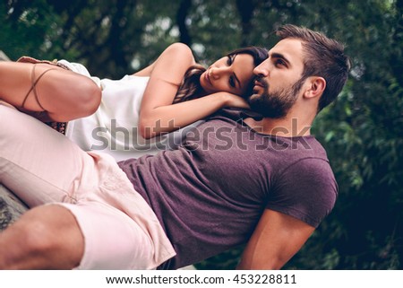 Girlfriend leaning on her boyfriend in the nature