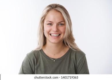 Girlfriend smiling feeling upbeat and happy laughing from love and amusement looking joyful at camera having funny conversation, grinning pleasantly posing against white background - Shutterstock ID 1401719363