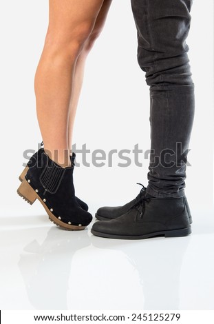 Girlfriend standing on her toes to reach and kiss her boyfriend