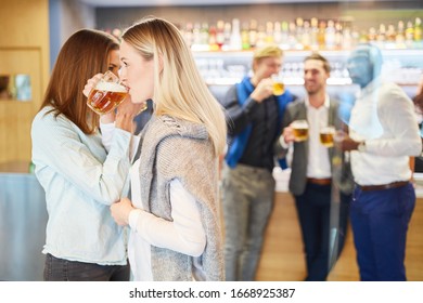 Girlfriends Are Drinking Fraternity With A Glass Of Beer In A Pub Or Pub