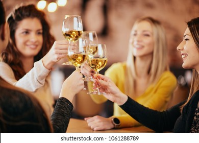 Girlfriends Drinking Wine And Chatting While Sitting In The Bar.