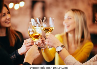 Girlfriends Drinking Wine And Chatting While Sitting In The Bar.