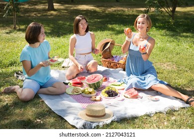 girlfriends has fun spending time together. lifestyle. three woman friends communicate at a picnic in the summer in the park - Powered by Shutterstock