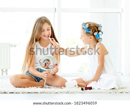 child girl playing checkers with her dad at home