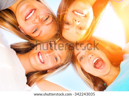 Similar – Young people with their heads together having fun