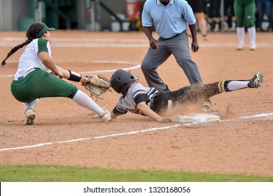 Girls In Action Playing In A Softball Game