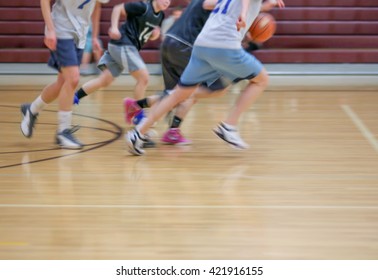 A Girls Basketball Team Running Up Or Down The Court With Motion Blur From A Slow Shutter Speed (NOTHING IS IN FOCUS) Toned With A Retro Vintage Instagram Filter Effect App Or Action 