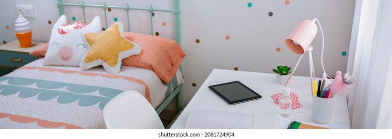 Girl's Bedroom With Bed And Desk Decorated In Pastel Colors