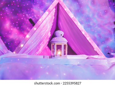 Girls birthday party sleepover with enchanted indoor camping tent lanterns and light projector decorations