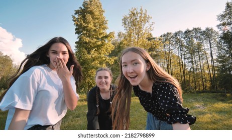 Girls blow a kiss at a picnic near the forest.