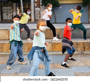 Girls And Boys Hip Hop Dancers In Protective Face Masks Doing Dance Workout During Open Air Group Class, Keeping Social Distance