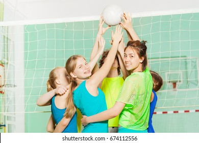 Girls And Boys Playing Volleyball In Gymnasium